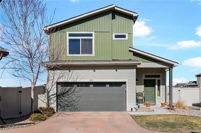 view of front of property featuring a garage, driveway, a gate, fence, and board and batten siding