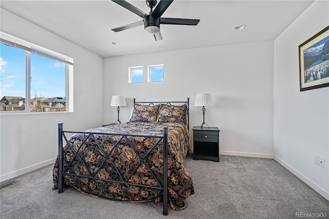 bedroom featuring ceiling fan, carpet floors, visible vents, and baseboards