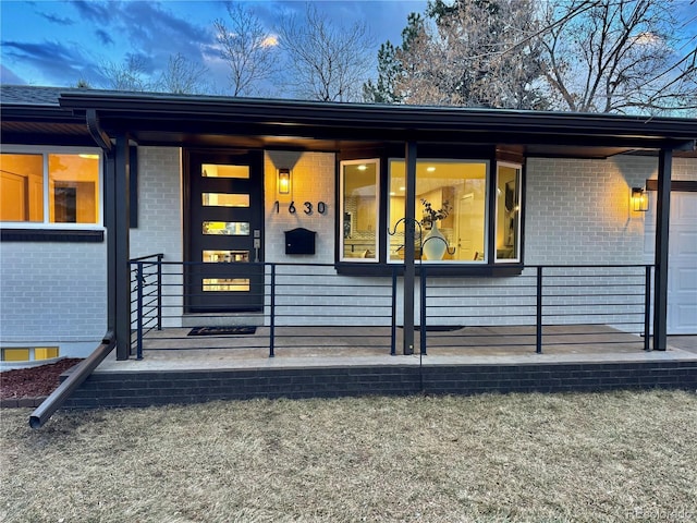 doorway to property featuring brick siding