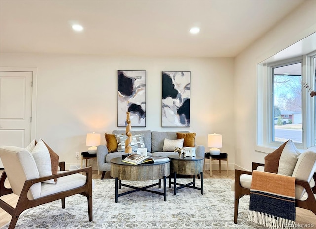 sitting room with baseboards, light wood-style floors, and recessed lighting