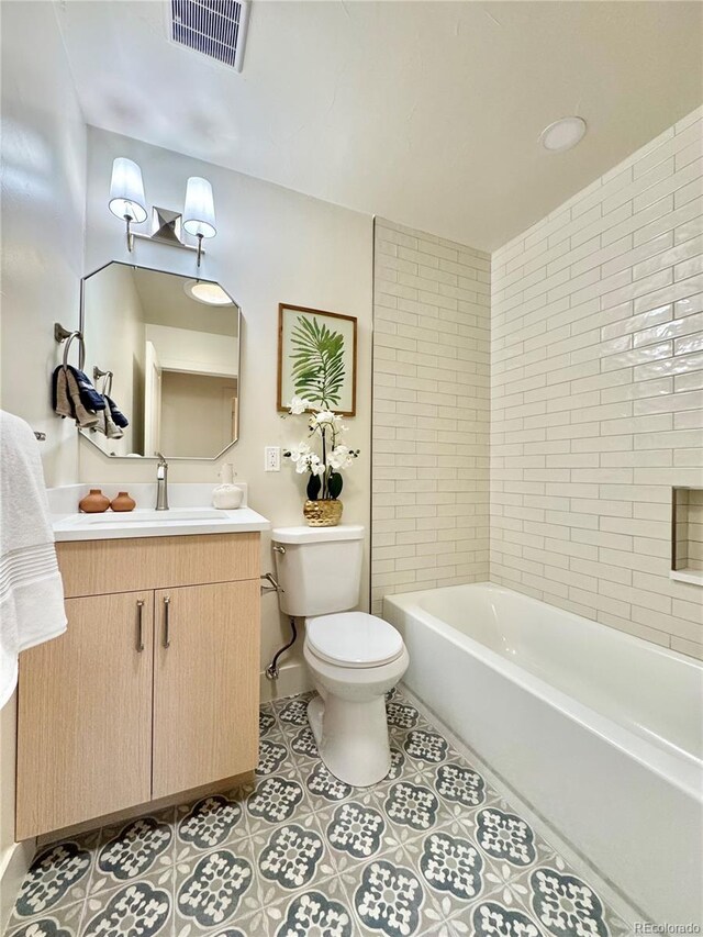 bathroom featuring visible vents, vanity, toilet, and tile patterned floors