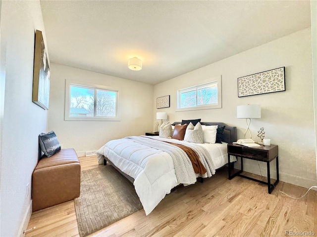 bedroom featuring light wood-style flooring and baseboards