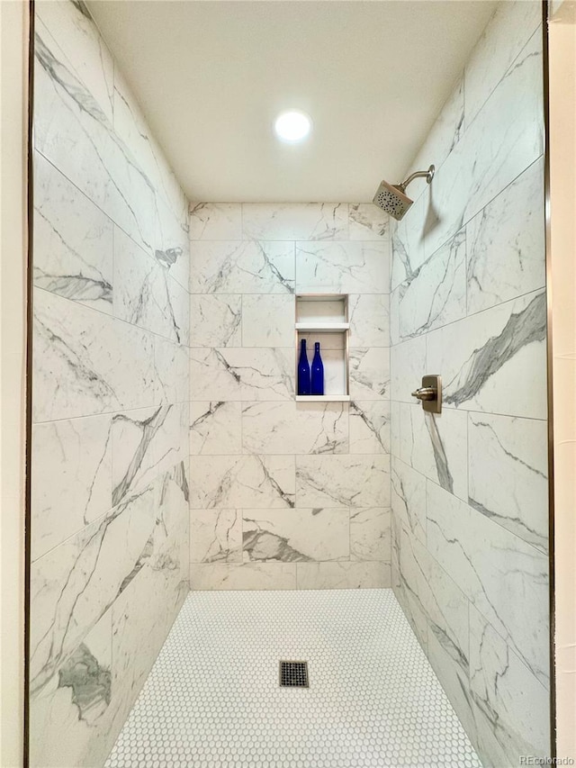 bathroom with a tile shower