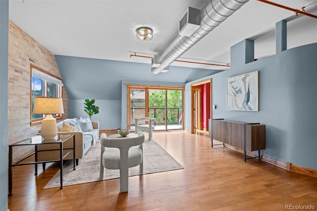 3299 Lowell Blvd Unit 204, Denver, CO 80211 - dining space with baseboards, wood finished floors, and brick wall