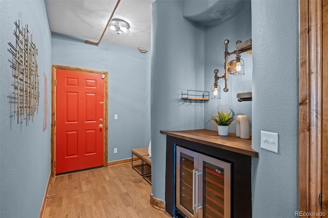3299 Lowell Blvd Unit 204, Denver, CO 80211 - foyer with light wood-style flooring, beverage cooler, and baseboards