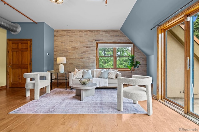 3299 Lowell Blvd Unit 204, Denver, CO 80211 - living area with brick wall and wood finished floors
