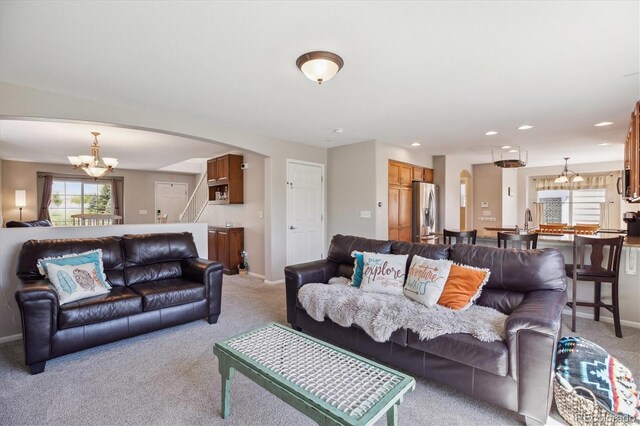 11866 High Desert Rd, Parker, CO 80134 - living area featuring a chandelier, arched walkways, light carpet, baseboards, and recessed lighting
