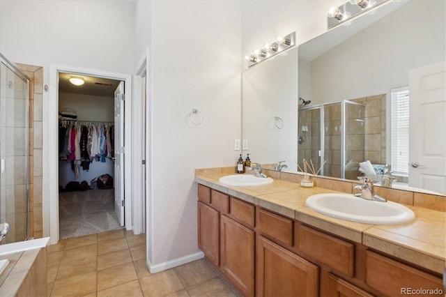 11866 High Desert Rd, Parker, CO 80134 - bathroom featuring a shower stall, tile patterned flooring, double vanity, and a walk in closet