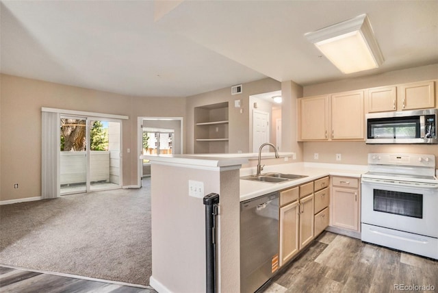 8707 E Florida Ave Unit 709, Denver, CO 80247 - kitchen featuring appliances with stainless steel finishes, a sink, light brown cabinetry, light countertops, and a peninsula