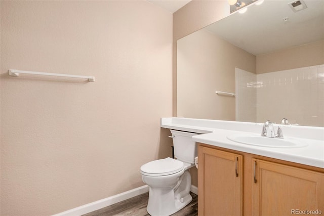 8707 E Florida Ave Unit 709, Denver, CO 80247 - bathroom featuring wood finished floors, toilet, vanity, and baseboards