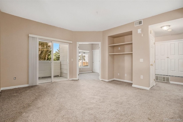 8707 E Florida Ave Unit 709, Denver, CO 80247 - unfurnished bedroom with access to exterior, carpet, and baseboards