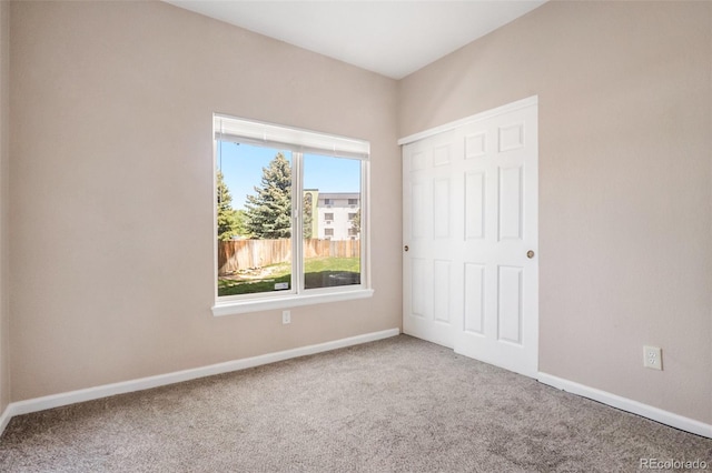 8707 E Florida Ave Unit 709, Denver, CO 80247 - unfurnished bedroom featuring carpet flooring, baseboards, and a closet