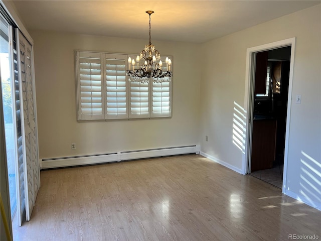 unfurnished dining area featuring hardwood / wood-style floors, a baseboard heating unit, and a notable chandelier