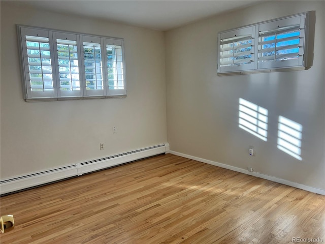 spare room with light hardwood / wood-style floors and a baseboard radiator