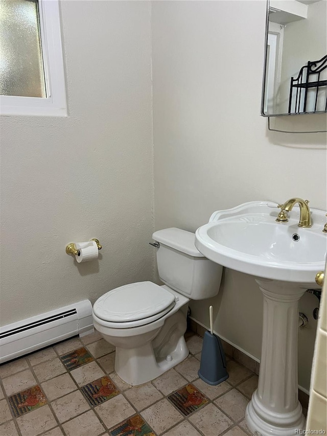 bathroom featuring toilet and a baseboard heating unit