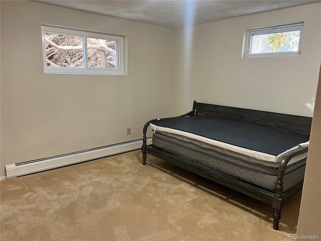 bedroom with light carpet, multiple windows, and a baseboard heating unit