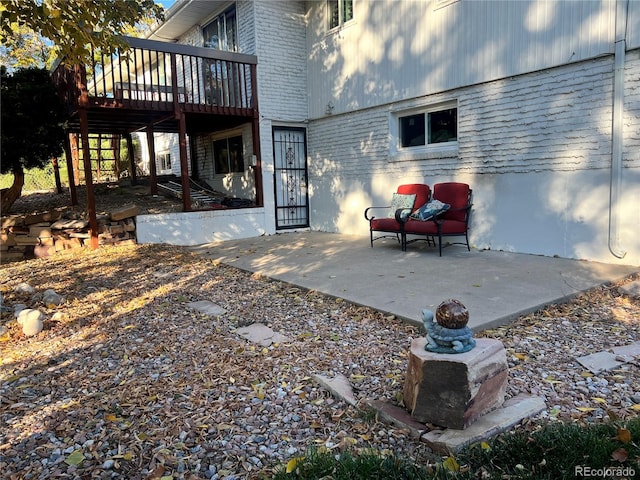2789 S Ivan Way, Denver, CO 80227 - back of house with brick siding, a deck, and a patio