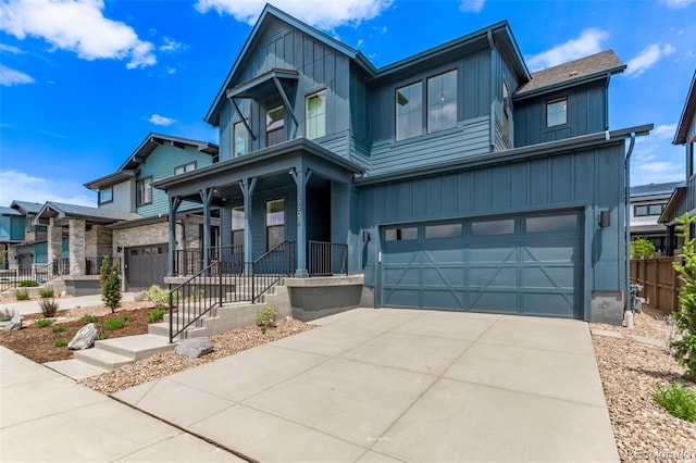 5608 Grandville Ave, Longmont, CO 80503 - modern home featuring board and batten siding, an attached garage, concrete driveway, and covered porch
