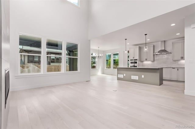 5608 Grandville Ave, Longmont, CO 80503 - unfurnished living room with light wood-style flooring, a chandelier, and recessed lighting