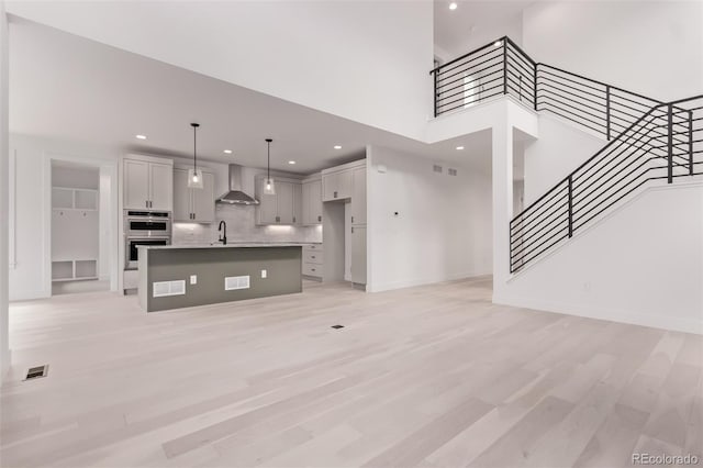 5608 Grandville Ave, Longmont, CO 80503 - unfurnished living room with recessed lighting, stairway, and light wood-type flooring
