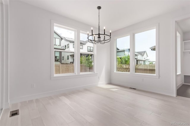 5608 Grandville Ave, Longmont, CO 80503 - unfurnished dining area featuring a chandelier and light wood-type flooring