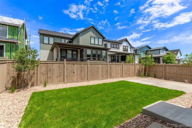5608 Grandville Ave, Longmont, CO 80503 - rear view of property with a fenced backyard and a residential view