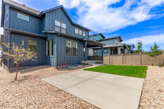 5608 Grandville Ave, Longmont, CO 80503 - back of property with board and batten siding and a patio area
