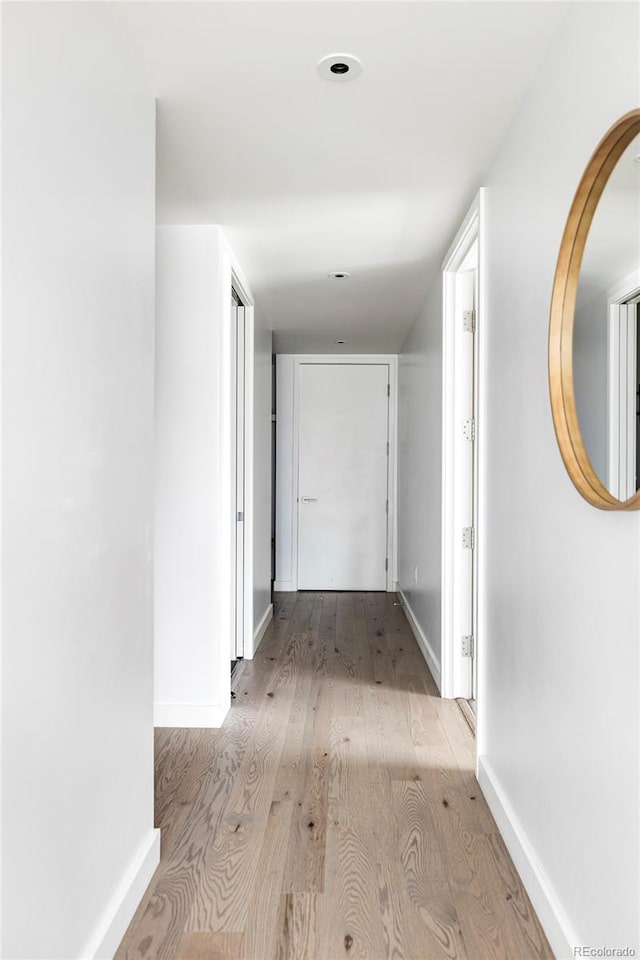 corridor with light hardwood / wood-style flooring