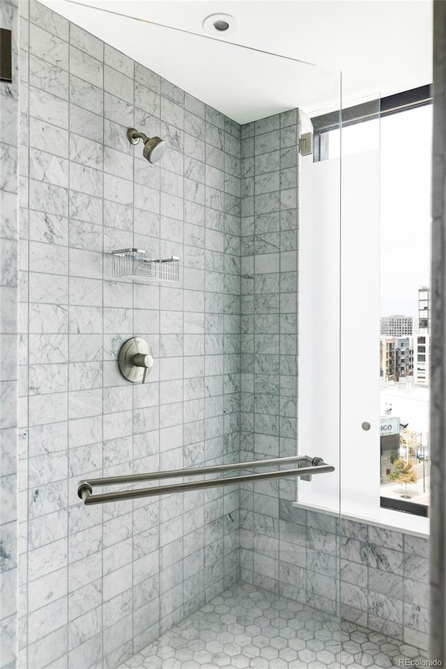 bathroom with a tile shower