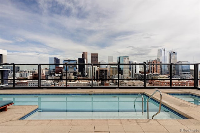 view of swimming pool with a hot tub