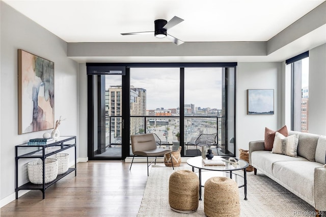 living room with hardwood / wood-style floors and ceiling fan