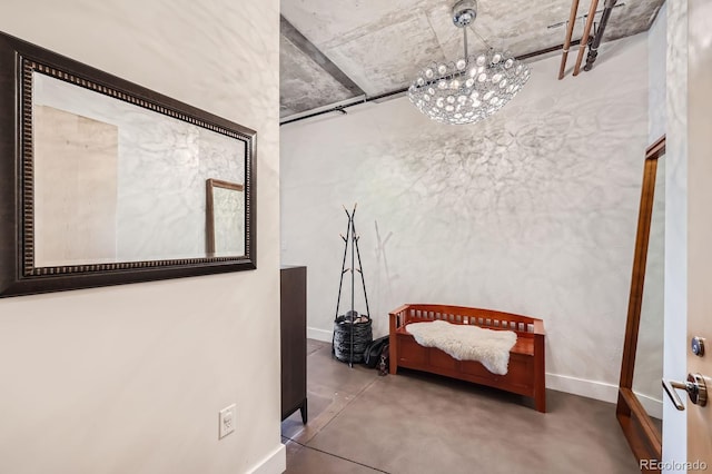 hallway with concrete floors and baseboards