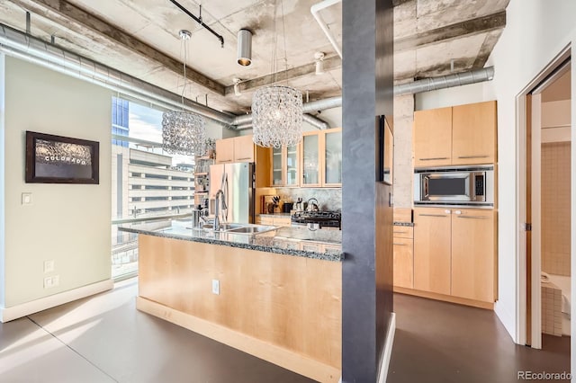 kitchen featuring tasteful backsplash, glass insert cabinets, stainless steel appliances, light brown cabinetry, and a sink