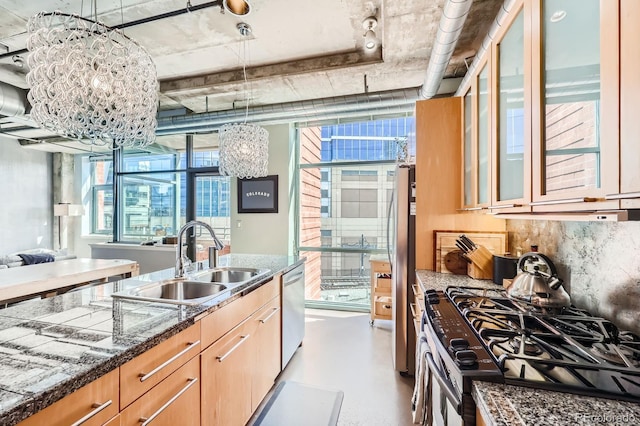 kitchen with stainless steel appliances, a sink, open floor plan, tasteful backsplash, and glass insert cabinets