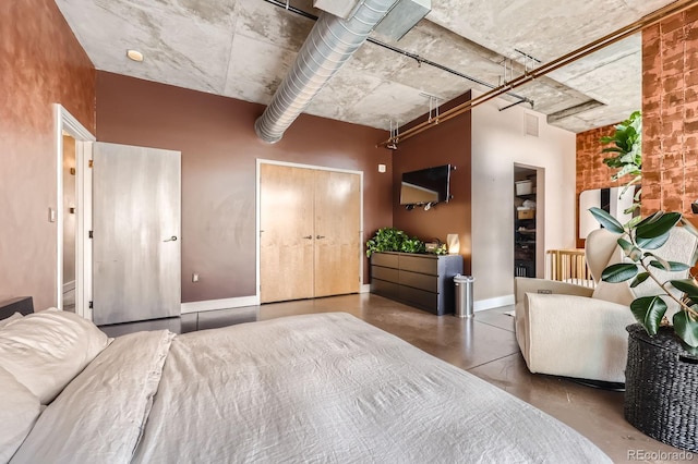 bedroom with concrete flooring, visible vents, and baseboards