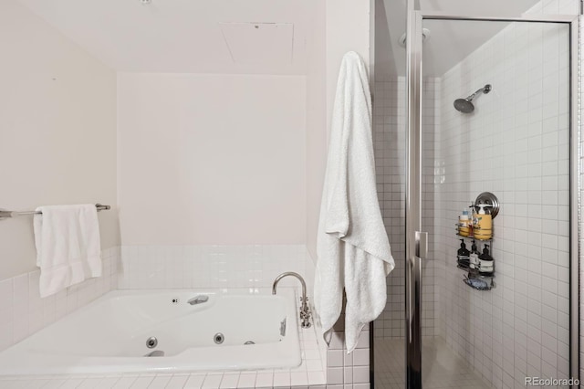 full bathroom featuring a shower stall and a tub with jets