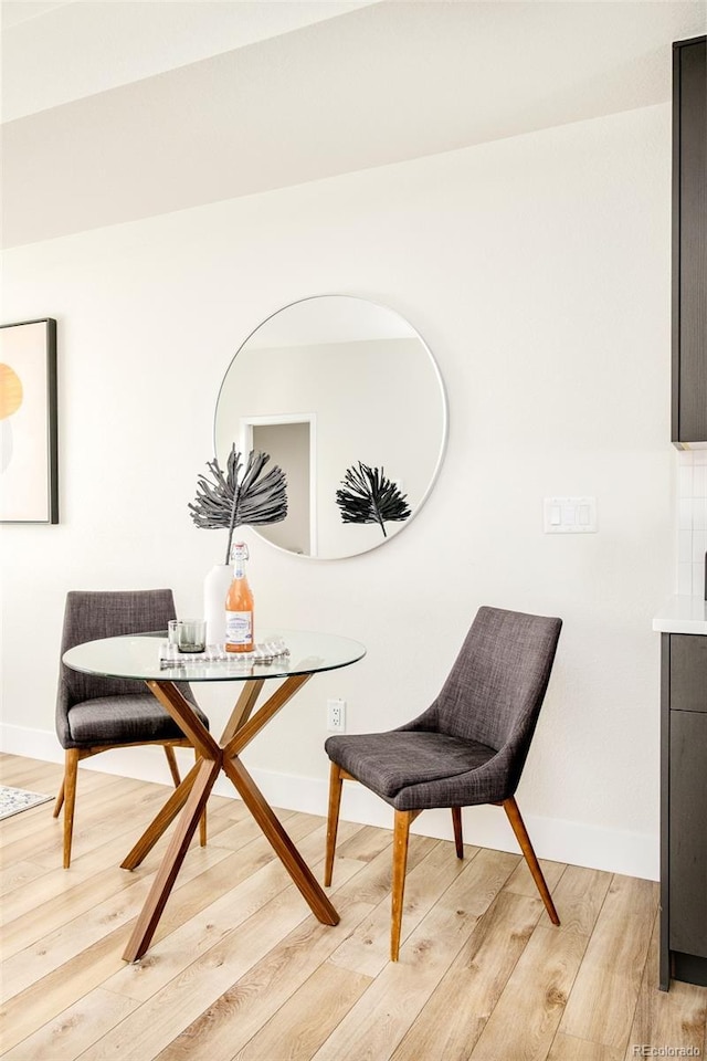 sitting room with light wood finished floors and baseboards