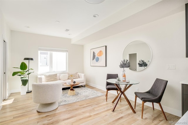 sitting room featuring light wood finished floors and baseboards