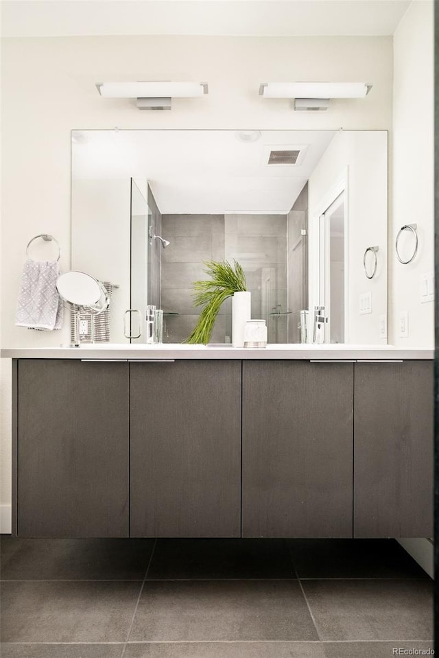 bathroom featuring visible vents, vanity, and tile patterned floors