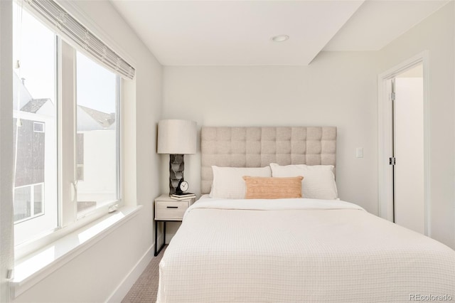 bedroom featuring multiple windows and baseboards