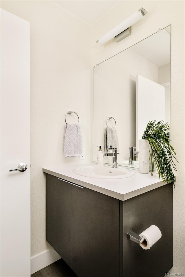 bathroom with vanity and baseboards