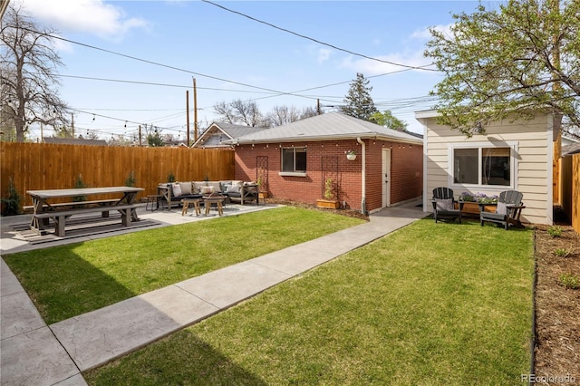 exterior space with fence, a patio, an outdoor living space, brick siding, and a yard