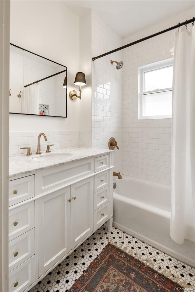 bathroom featuring shower / bath combo and vanity