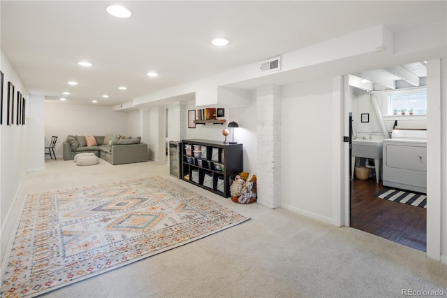 living area featuring carpet flooring, recessed lighting, baseboards, washer / dryer, and visible vents
