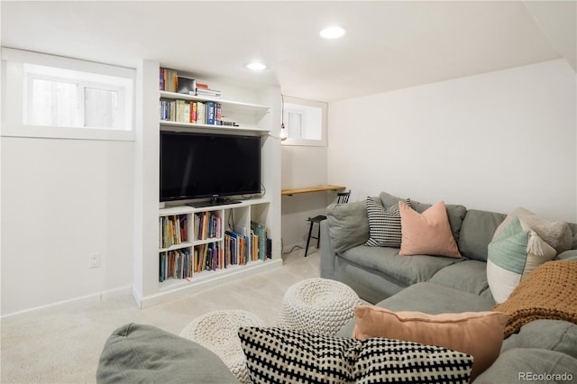 carpeted living area with recessed lighting and baseboards