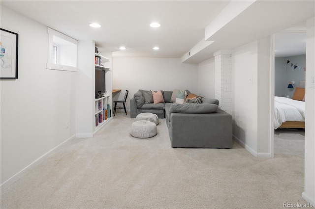 carpeted living area featuring baseboards and recessed lighting