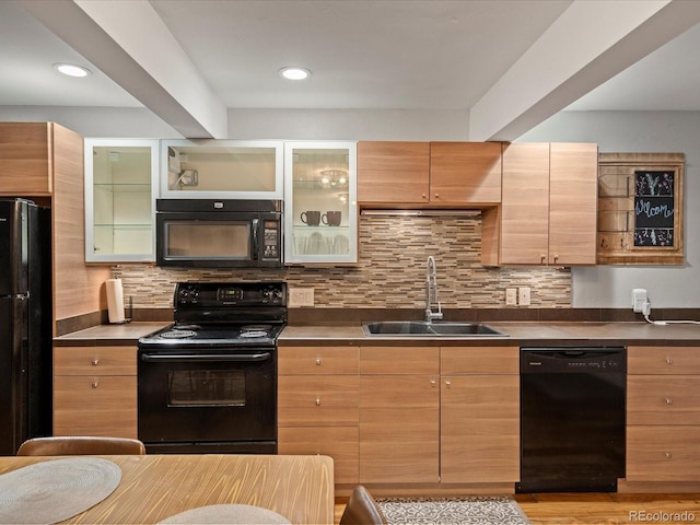 5873 S Prince St Unit 209B, Littleton, CO 80120 - kitchen featuring a sink, black appliances, glass insert cabinets, and decorative backsplash