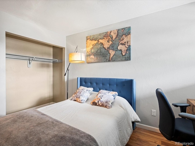 5873 S Prince St Unit 209B, Littleton, CO 80120 - bedroom featuring baseboards and wood finished floors