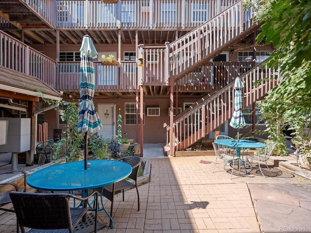5873 S Prince St Unit 209B, Littleton, CO 80120 - view of patio / terrace with outdoor dining area and stairs