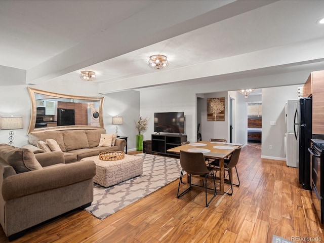 living room featuring light hardwood / wood-style flooring and a notable chandelier